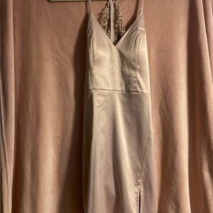 A beautiful pink silk dress with a lace design in the back